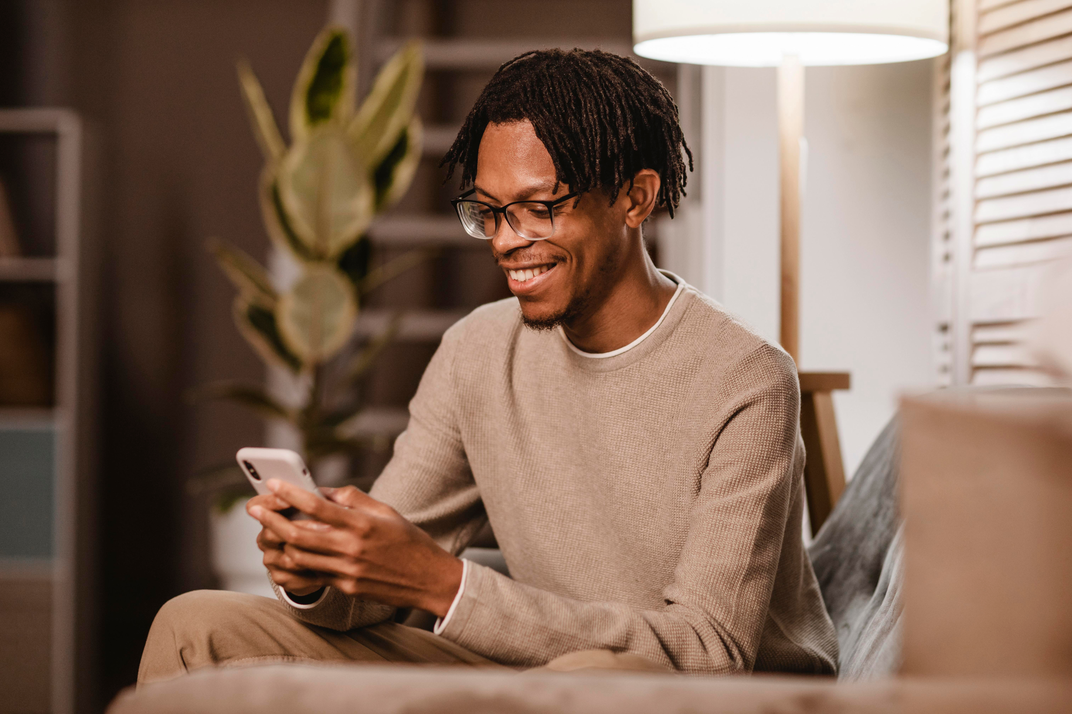 man using smartphone while at home on couch